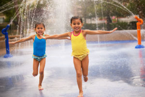 Girls running through a water park at Southern Highlands private golf community of las vegas Nevada